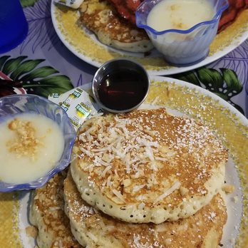 808 Grindz Cafe - Macadamia Nut Pancakes in front!  Tip: You can ask for different flavors for a dollar more. I say it's worth trying everything! - Cafes Near Me - Lahaina, Hawaii