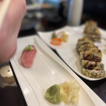 Wasabi - a person eating sushi - Sushi Bars Near Me - Mount Pleasant, South Carolina