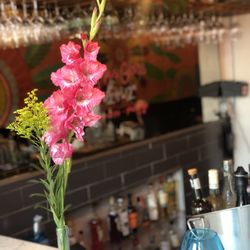 Trapeze - Flowers in entrance on the bar