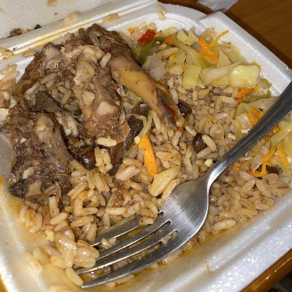 a plate of rice with meat and vegetables