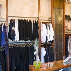 Kiki Hughes - The front room showing some of the clothing racks and the ceiling to floor slate waterfall