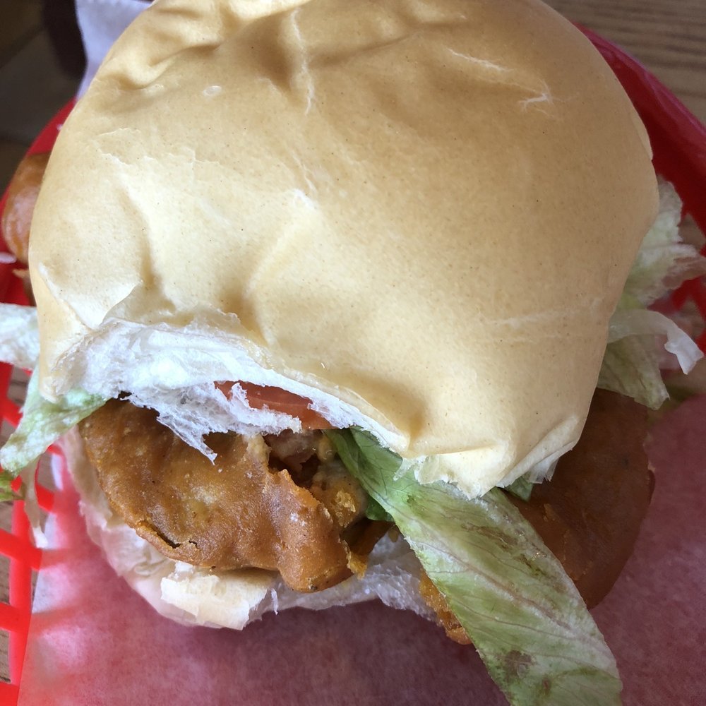 Isabela Latin Seafood - Fried fish sandwich with lettuce and tomato - Seafood Near Me - West Palm Beach, Florida Isabela Latin Seafood - Fried fish sandwich with lettuce and tomato - Seafood Near Me - West Palm Beach, Florida