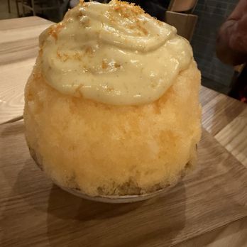 Ernest - Shaved ice covered with citrus syrup and underneath is a pana cotta that is covered by the ice. - New American Near Me - San Francisco, California Ernest - Shaved ice covered with citrus syrup and underneath is a pana cotta that is covered by the ice. - New American Near Me - San Francisco, California