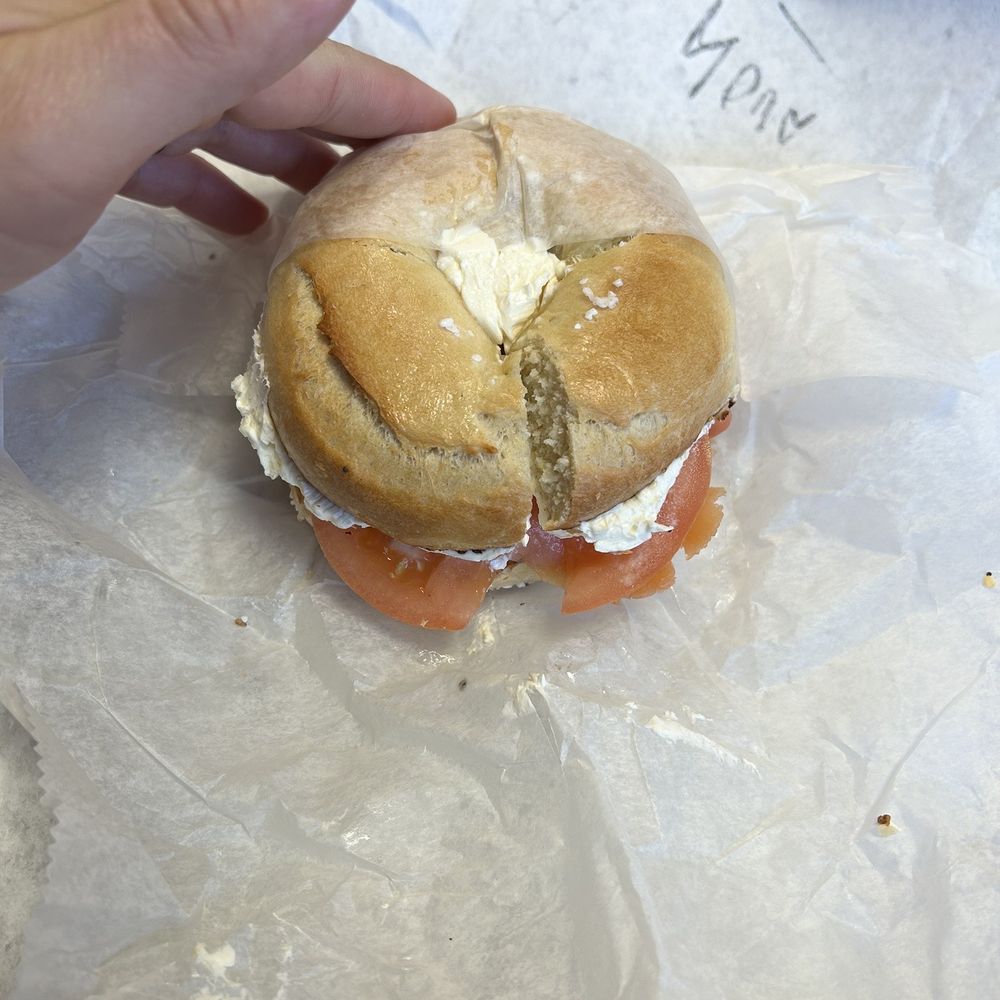 Huge salt bagel with lox, cream cheese, capers, and sliced red onion Huge salt bagel with lox, cream cheese, capers, and sliced red onion