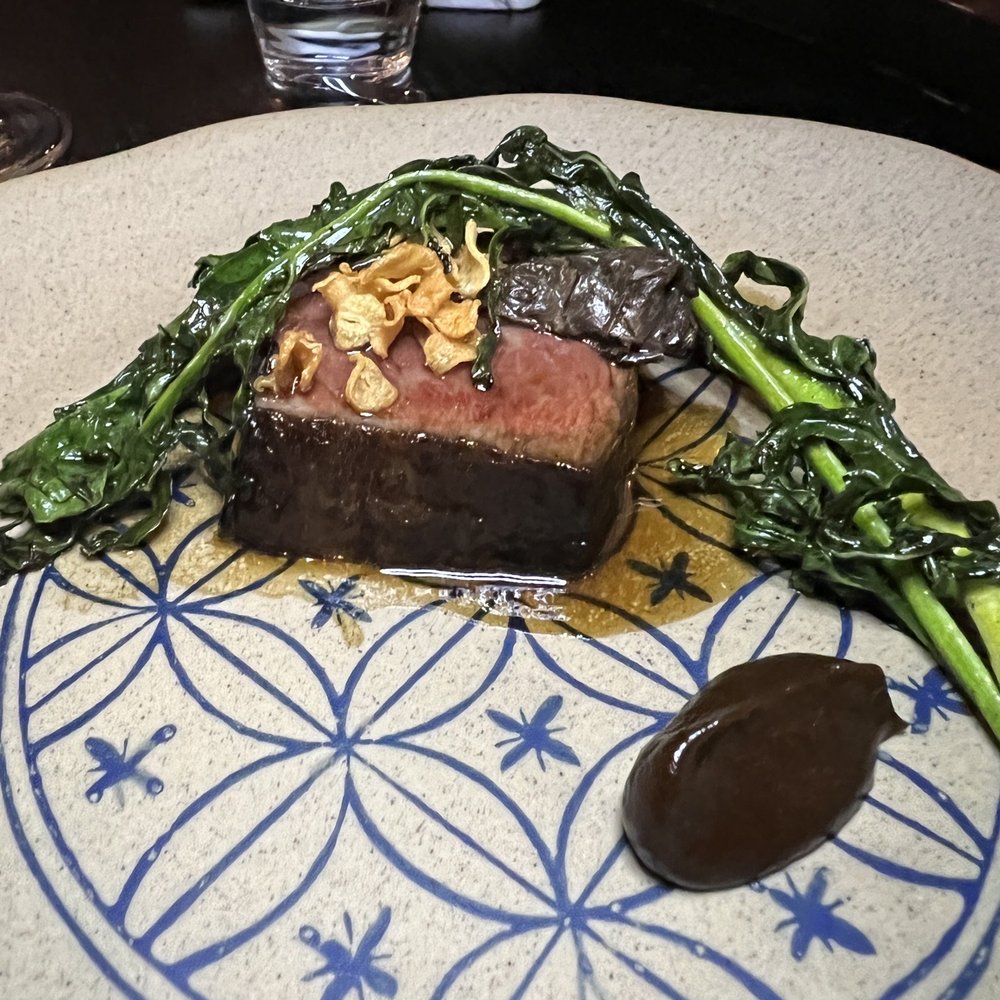 Maison Sun - American Wagyu Zabuton Black Garlic Soubise, Bone Marrow Jus, Confit Black Truffle, Crispy Garlic & Spigarello - French Near Me - Brooklyn , New York Maison Sun - American Wagyu Zabuton Black Garlic Soubise, Bone Marrow Jus, Confit Black Truffle, Crispy Garlic & Spigarello - French Near Me - Brooklyn , New York