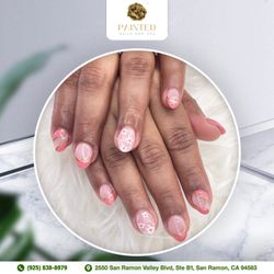 Painted Nails and Spa - Adorn your nails with a charming pink and flower design, capturing the essence of elegant beauty.