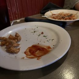 Empty shrimp plate and a full bowl of spaghetti because the pasta was overcooked. Empty shrimp plate and a full bowl of spaghetti because the pasta was overcooked.