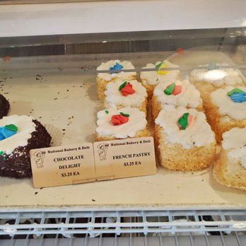 National Bakery & Deli - French Pastry--yellow cake coated with frosting and toasted coconut (on right) - Bakeries Near Me - Milwaukee, Wisconsin National Bakery & Deli - French Pastry--yellow cake coated with frosting and toasted coconut (on right) - Bakeries Near Me - Milwaukee, Wisconsin