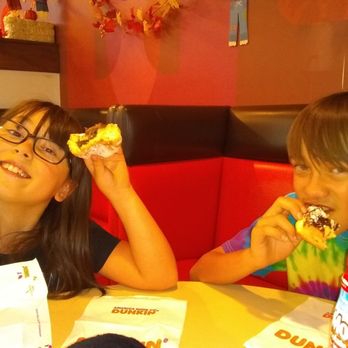 Dunkin' -  two children eating donuts at a restaurant - Donuts Near Me - Las Cruces, New Mexico