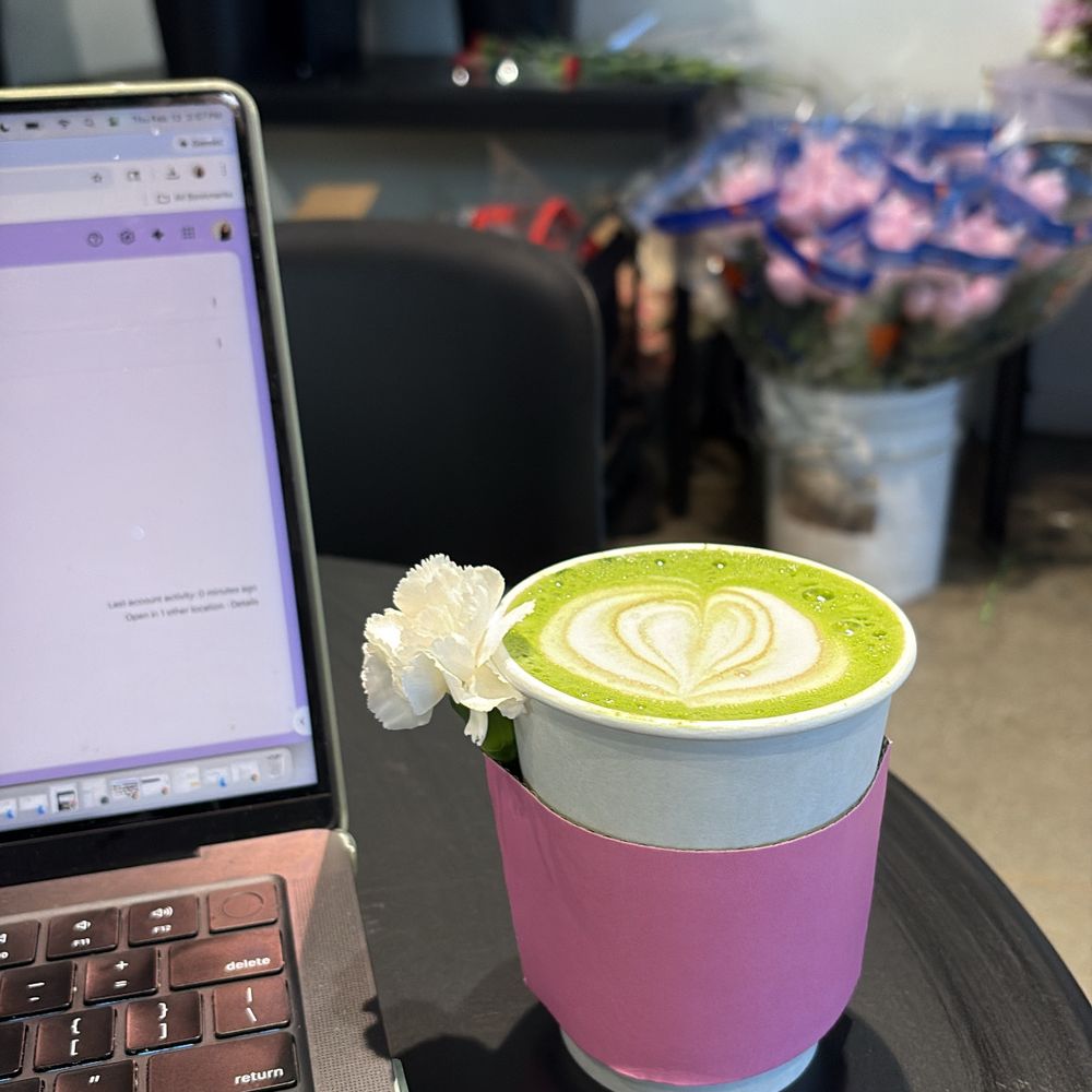 Bloomsgiving - I get their oat milk matcha unsweetened and it's so good. Flower bouquets in the background as they were setting up for Valentine's Day :) - Florists Near Me - Redwood City, California