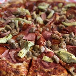 Bernillo's Pizzeria & Subs - Large all meat pizza. We added artichoke hearts.