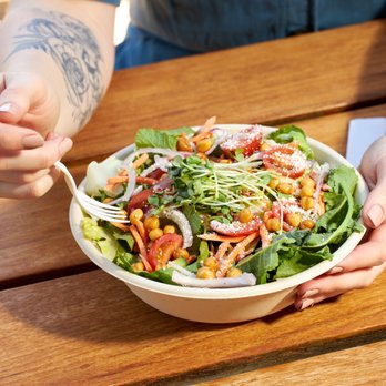 Burger Lounge - a woman eating a salad - Burgers Near Me - Campbell, California Burger Lounge - a woman eating a salad - Burgers Near Me - Campbell, California
