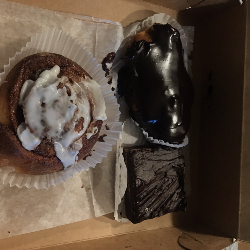a half eaten doughnut and a half eaten chocolate cake