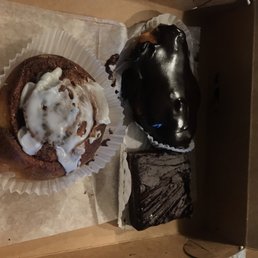 a half eaten doughnut and a half eaten chocolate cake