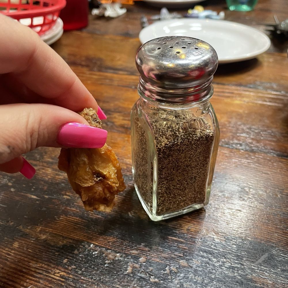 Fire On The Mountain - One wing, pepper shaker for scale. - Barbeque Near Me - Portland, Oregon Fire On The Mountain - One wing, pepper shaker for scale. - Barbeque Near Me - Portland, Oregon