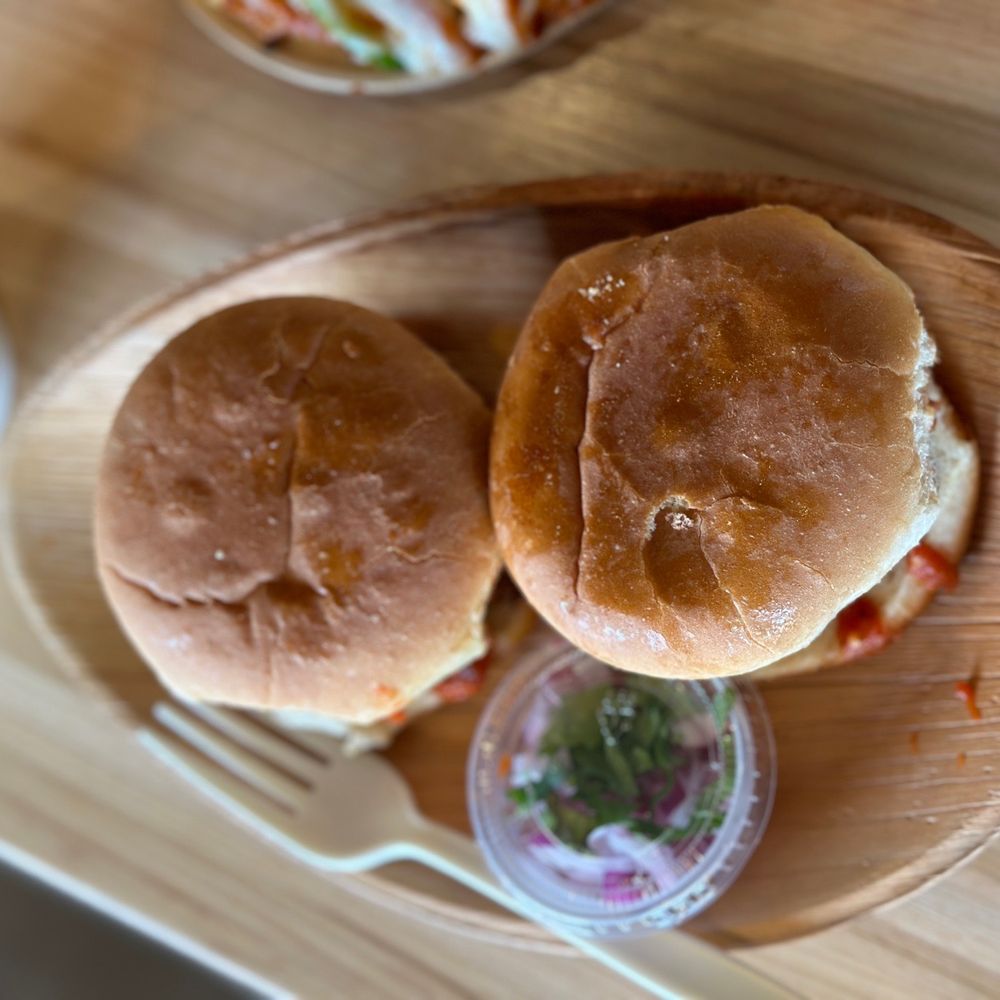 PIZZA KARMA | Food Truck Catering - Eden Prairie - two sandwiches on a wooden plate - Pizza Near Me - Eden Prairie, Minnesota PIZZA KARMA | Food Truck Catering - Eden Prairie - two sandwiches on a wooden plate - Pizza Near Me - Eden Prairie, Minnesota