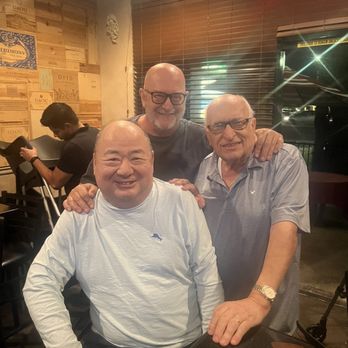 Andiamo Ristorante Italiano - Carlo (Owner & Chef of Andiamo) Center, Frank Paolilli-right side,  Notice the high end wine wood box  labels on the walls! - Italian Near Me - Clovis, California