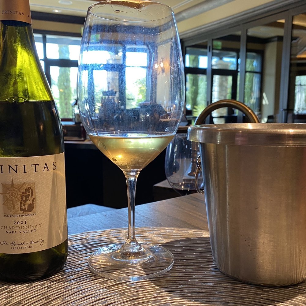Trinitas Cellars - a glass of wine and a bottle of wine - Wine Tasting Room Near Me - Napa, California Trinitas Cellars - a glass of wine and a bottle of wine - Wine Tasting Room Near Me - Napa, California