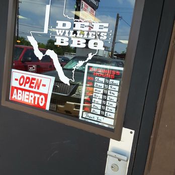 Dee Willie’s BBQ  - Entry door to Dee Willie's.  Hours of operation posted - Barbeque Near Me - San Antonio, Texas