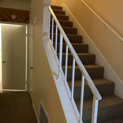 Lake Arrowhead Chalets - Staircase with half bath/laundry room behind door