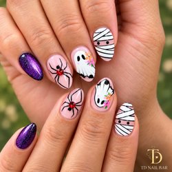TD Nail Spa - Spooky season, but make it cute! Mummies, little ghosts, sparkling spiders & a touch of purple glam -- the perfect Halloween nail set!