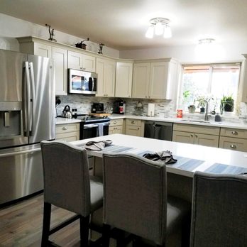 Holly Home Improvement - Custom color cabinets, quartz counters and tile backsplash brightened and modernized this kitchen - General Contractors Near Me
