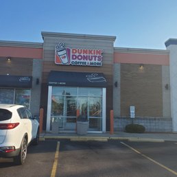 a car parked in front of a dunkin donuts coffee shop a car parked in front of a dunkin donuts coffee shop