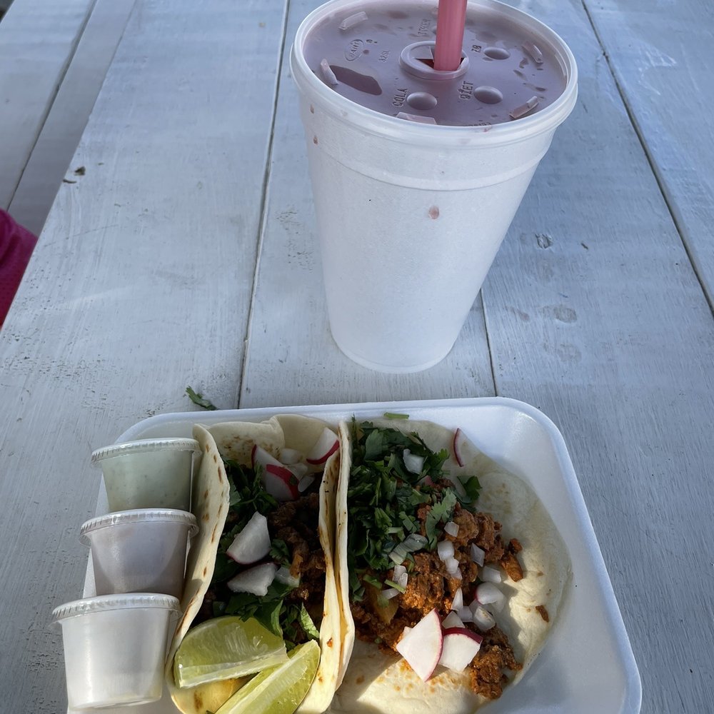 Tacos (al pastor and bistec) with salsa and watermelon aqua fresca