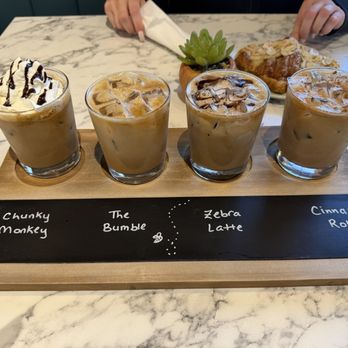 Niyyah Coffee - Coffee flight with almond croissant in the background - Coffee & Tea Near Me - Markham, Ontario