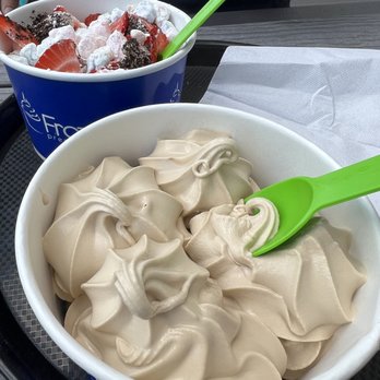 Frozen Falls  - Espresso flavor with no toppings. Liked the flavor a lot! - Two cups of frozen yogurt are on a table, one with vanilla flavor and the other with strawberries, chocolate cookies, and whipped toppings. - Ice Cream & Frozen Yogurt Near Me - Basking Ridge, New Jersey
