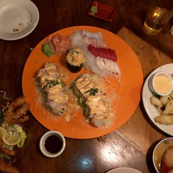 Godai - Longhorn rolls w escolar, yellowtail, tuna, & scallop sashimi on main tray. Soft shell crab-left & peppered calamari-right. - Sushi Bars Near Me - San Antonio, Texas