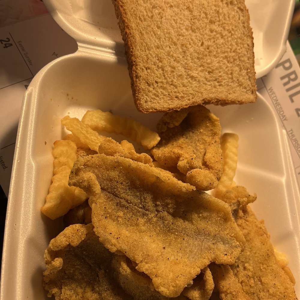 Catfish sandwich with fries. Catfish sandwich with fries.