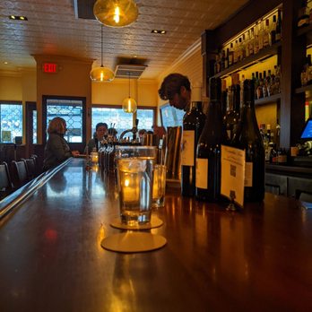 Blueprint - a man at a bar with a glass of wine - Cocktail Bars Near Me - Brooklyn, New York