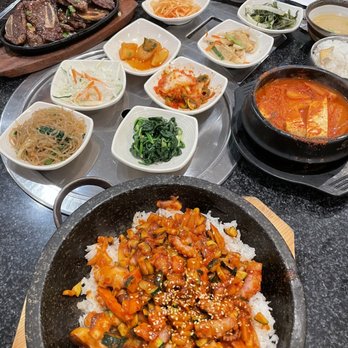 Seoul Garden - Octopus hot stone bibimbap, galbi (back left), kimchi jigae (soup), and banchon (the little side dishes) - Korean Near Me - Dallas, Texas