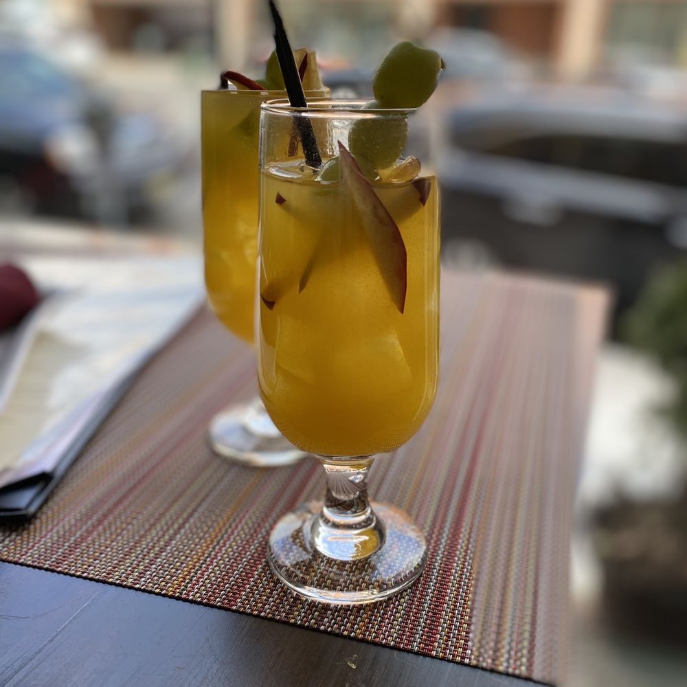 two glasses of drink on a table