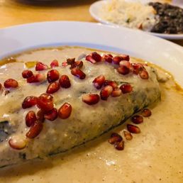 Poblano pepper stuffed with unique flavors topped with pomegranate