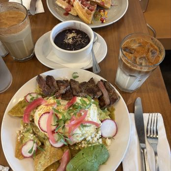 Poached Neighborhood Kitchen - Chilaquiles verdes with steak & side of black beans. Iced dulce de leche latte. Seasonal waffle - Breakfast & Brunch Near Me - Downey, California Poached Neighborhood Kitchen - Chilaquiles verdes with steak & side of black beans. Iced dulce de leche latte. Seasonal waffle - Breakfast & Brunch Near Me - Downey, California