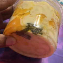 This shows the greens in the bottom of the container of Mac n cheese. And you can tell the amount of grease in the container by the bubbles! This shows the greens in the bottom of the container of Mac n cheese. And you can tell the amount of grease in the container by the bubbles!