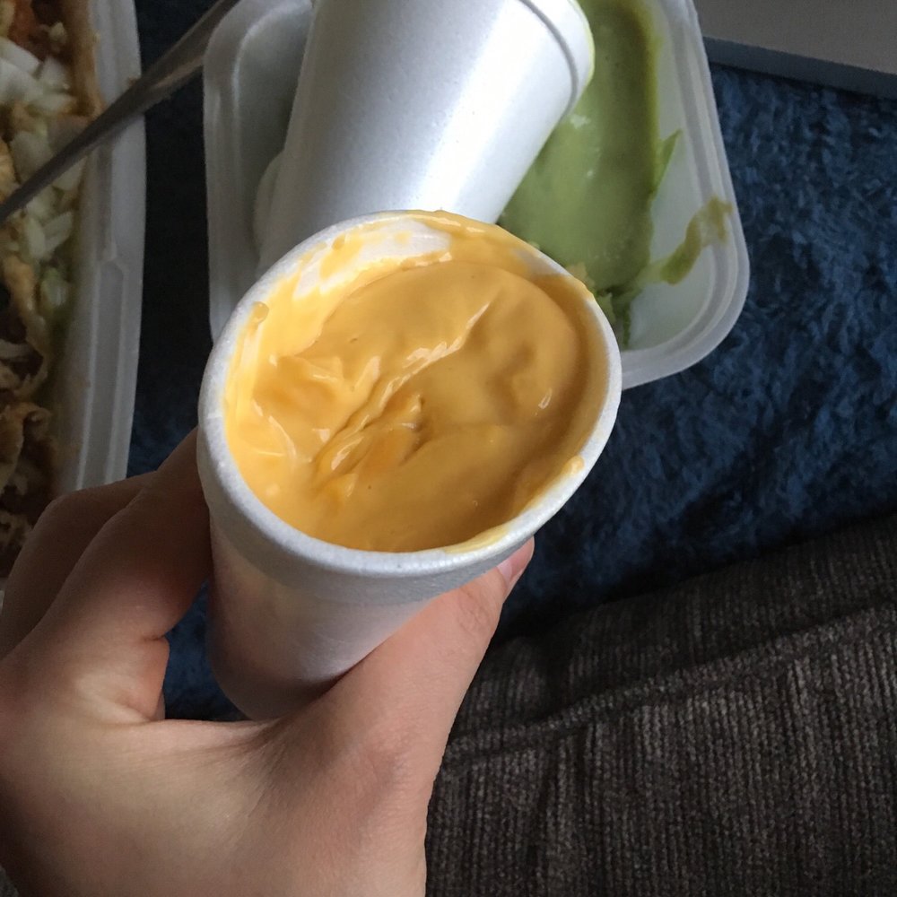 Hillside Cafe - a hand holding a cup of mustard sauce - Mexican Near Me - Manhattan, Kansas Hillside Cafe - a hand holding a cup of mustard sauce - Mexican Near Me - Manhattan, Kansas