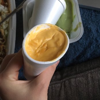 Hillside Cafe - a hand holding a cup of mustard sauce - Mexican Near Me - Manhattan, Kansas