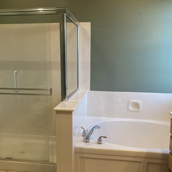 Iron Hands construction - a bathtub and shower in a bathroom - General Contractors Near Me Iron Hands construction - a bathtub and shower in a bathroom - General Contractors Near Me