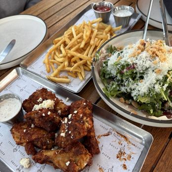 Truly Pizza - Classic French Fries, Honey Harissa Chicken Wings, Spagnola Salad - Pizza Near Me - Dana Point, California