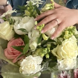 Beautiful bouquet for engagement party.  Assortment of white flowers and one pink rose to represent their daughter.  Lovely centerpiece too