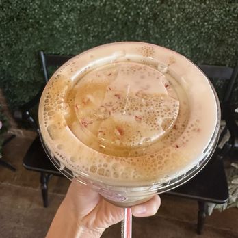 Ana's Confections - Iced white chocolate espresso with a peppermint cold foam topped with crushed candy cane - Bakeries Near Me - Rosenbeg, Texas