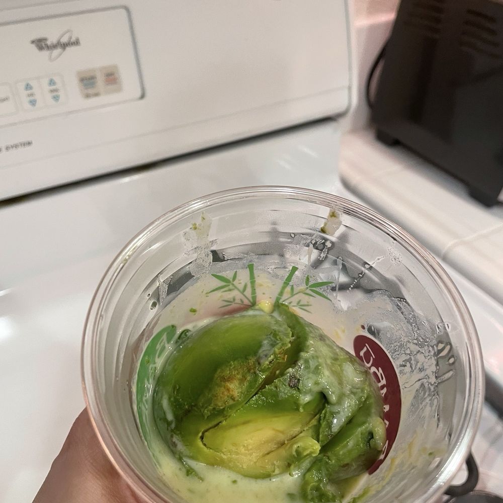 Pic of the avocado shoved in the cup without anyone caring do at least mix it with the condensed milk.
