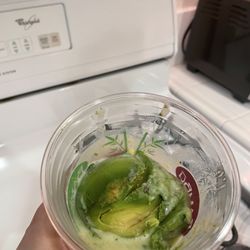 Pic of the avocado shoved in the cup without anyone caring do at least mix it with the condensed milk.