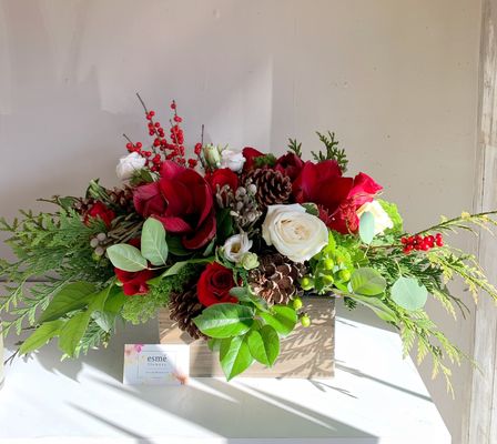 Holiday arrangements - An assortment of holiday arrangements in winter whites or crimson reds with pinecones and berries.