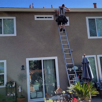 Andy's Rain Gutters - Matt installing our rain gutters on the roofline up about 25 feet. - Gutter Services Near Me