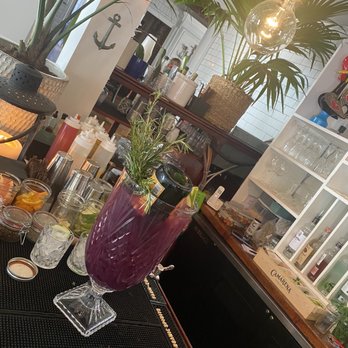 Waterdog Kitchen + Bar - $120 table cocktail with a bottle of champagne and a bunch of seared rosemary. - American Near Me - Warren, Rhode Island Waterdog Kitchen + Bar - $120 table cocktail with a bottle of champagne and a bunch of seared rosemary. - American Near Me - Warren, Rhode Island