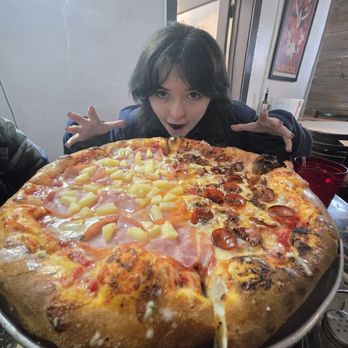 Old Town Pizza Parlor - Half pineapple Canadian bacon and half pep and normal bacon and a hungry hungry individual - Pizza Near Me - Albuquerque, New Mexico